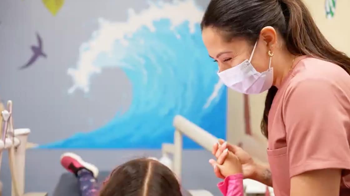 Assistant Smiling At Child